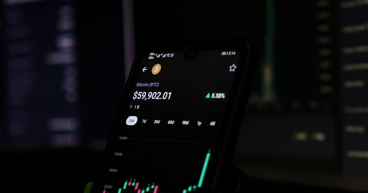 Un celular muestra el gráfico de precio de una criptomoneda.
